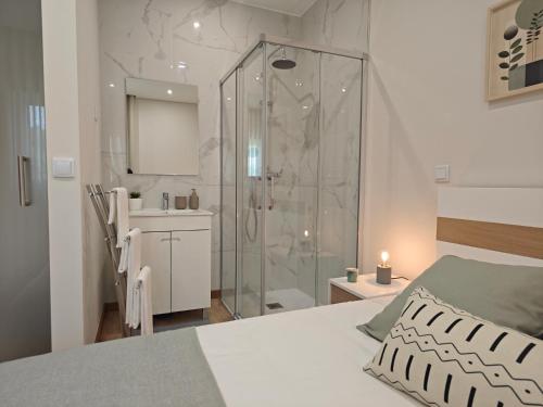 a bedroom with a shower and a bed and a bathroom at Casa da Milinha - Villa with a Pool near Rio Douro in Santa Cruz do Douro