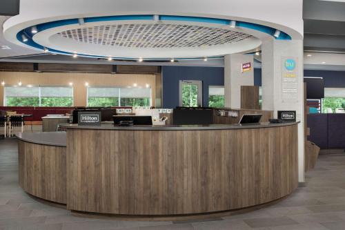 a large lobby with a reception counter in a hospital at Tru By Hilton Charlotte Airport Lake Pointe in Charlotte