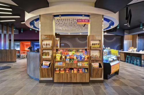 a store with a food section with products on display at Tru By Hilton Denver South Park Meadows, Co in Lone Tree