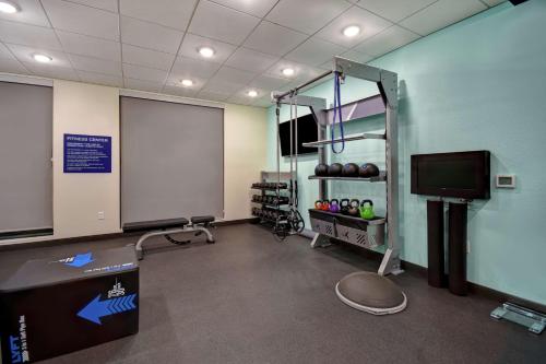 a gym room with a screen and a tv at Tru By Hilton Denver South Park Meadows, Co in Lone Tree