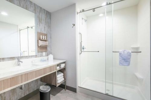 a bathroom with a shower and a sink at Hilton Garden Inn Wichita Downtown, Ks in Wichita
