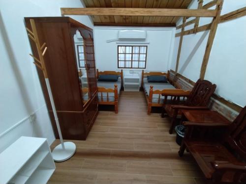 a hallway with chairs and a bed in a room at 順耆自然Shun Ci Zih Ran in Xingang