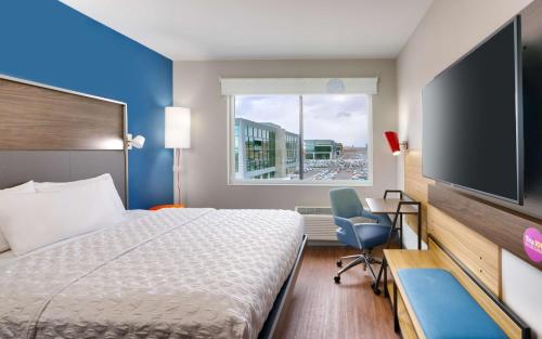 um quarto de hotel com uma cama e uma televisão de ecrã plano em Tru By Hilton Lehi, Ut em Lehi