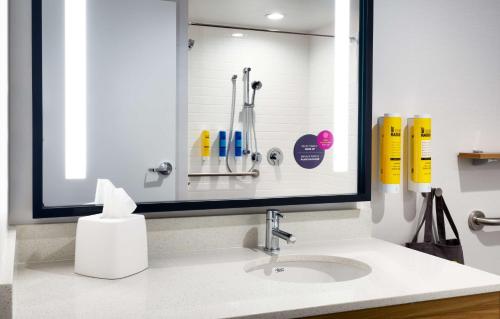 a bathroom sink with a mirror over a sink at Tru By Hilton Lehi, Ut in Lehi