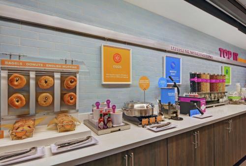 a bakery counter with pastries and donuts on display at Tru By Hilton Springfield Downtown in Springfield