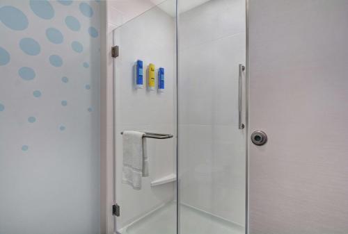 a shower with a glass door in a bathroom at Tru By Hilton Springfield Downtown in Springfield