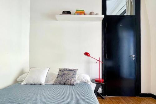 里斯本的住宿－Central Hidden Gem Rustic Modern 2 Bedroom Flat，一间卧室设有一张床和一个黑色的门