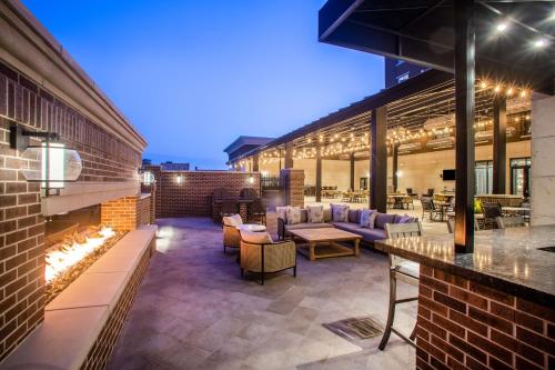 a patio with a fireplace in a building at Homewood Suites By Hilton Salina/Downtown, Ks in Salina