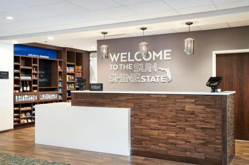 a welcome to the sun shinessafe sign in a store lobby at Hampton Inn Clewiston in Clewiston