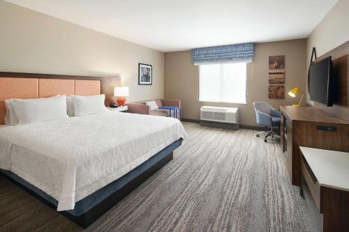 a hotel room with a bed and a television at Hampton Inn Clewiston in Clewiston