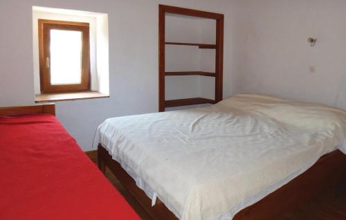 a small bedroom with a bed and a window at Mountain house SKULIN in Novi Vinodolski
