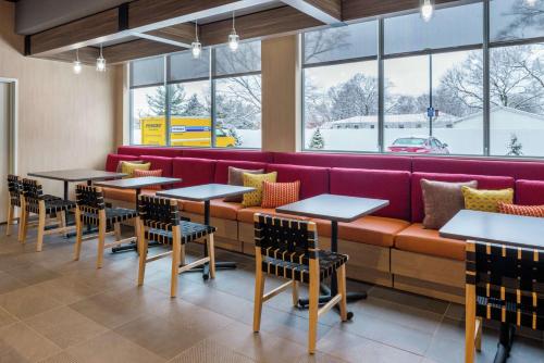 a row of tables and chairs in a restaurant at Tru By Hilton Elkhart, In in Elkhart