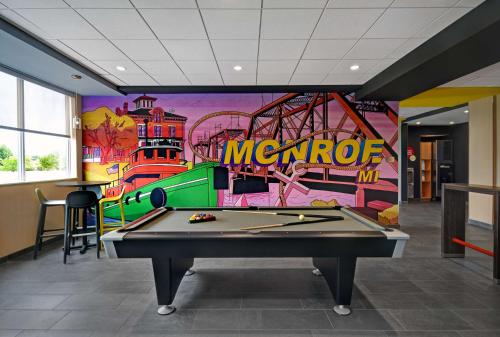 a pool table in a room with a mural at Tru By Hilton Monroe, MI in Monroe