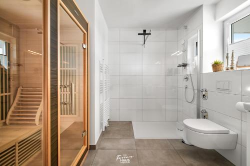 a bathroom with a toilet and a walk in shower at Kap der Guten Hoffnung in Olpenitz