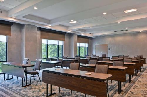 a classroom with tables and chairs in a room with windows at Hampton Inn & Suites Tampa Riverview Brandon in Tampa
