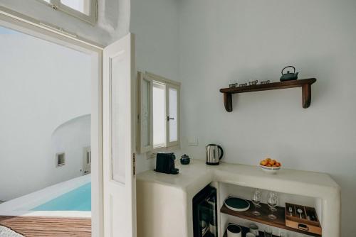 a bathroom with a bath tub in a room at Villa Patitiri cave house with private pool in Megalochori Santorini in Megalokhori