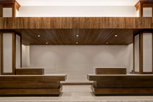 a lobby with two benches and a large window at Homewood Suites By Hilton Summerville in Summerville