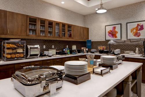 a kitchen with a counter with plates on it at Homewood Suites By Hilton Summerville in Summerville