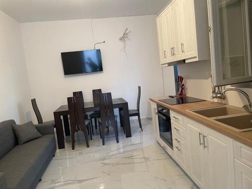 a kitchen and living room with a table and a couch at Diakofti house by the sea in Kýthira