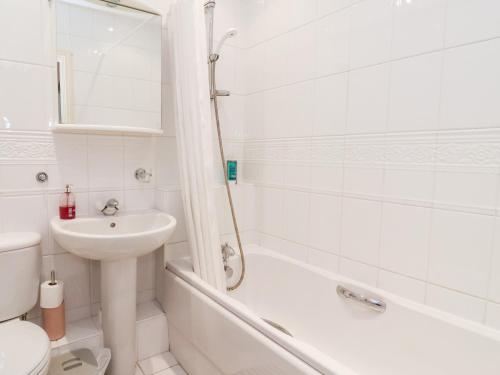 a bathroom with a sink and a toilet and a bath tub at 1 Cockerill Fold in Beverley