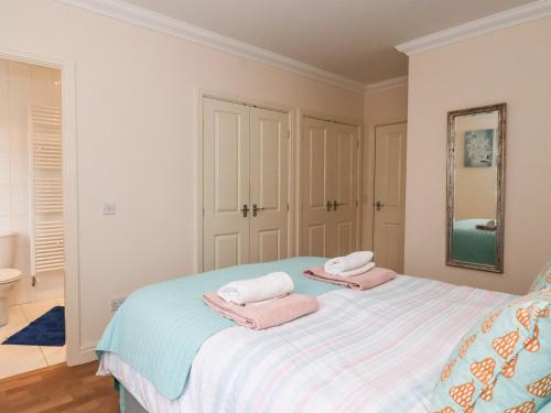 a bedroom with a bed with towels on it at 1 Cockerill Fold in Beverley
