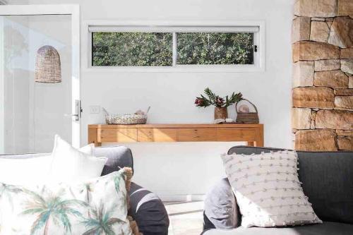a living room with a chair and a window at Bawley Point Oasis - Steps from Bawley Beach in Bawley Point