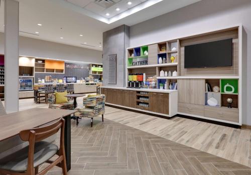 a store with a tv and a table and chairs at Home2 Suites By Hilton Euless Dfw West, Tx in Euless