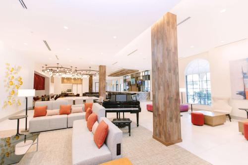a living room with couches and a piano at Hilton Garden Inn Winter Park, FL in Orlando