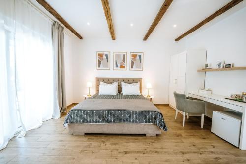 a bedroom with a large bed and a desk at Old Town Zagreb Airport in Velika Gorica