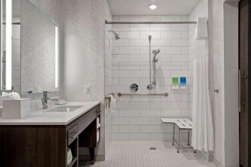a white bathroom with a sink and a shower at Home2 Suites By Hilton Lewisville Dallas in Lewisville