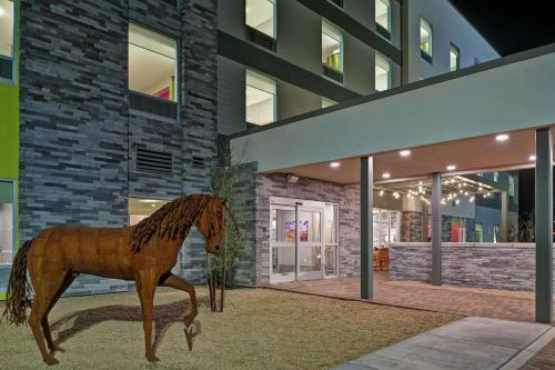 a statue of a horse in front of a building at Home2 Suites By Hilton Buckeye Phoenix in Buckeye
