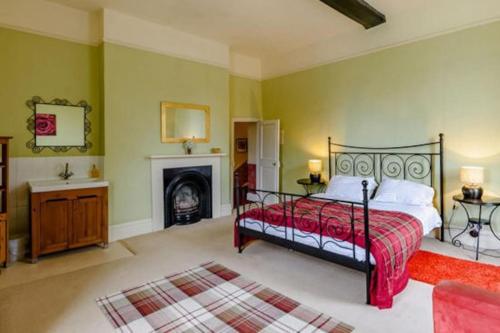 a bedroom with a bed and a fireplace at Dunham House in Newark-on-Trent