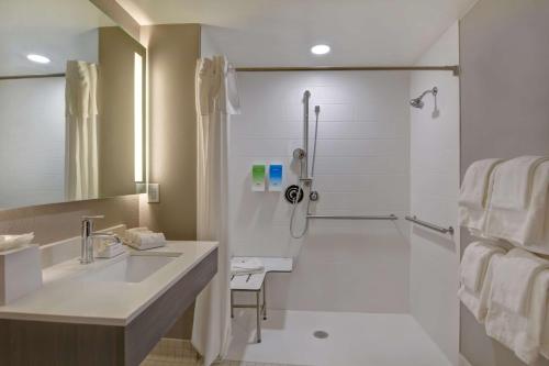 a bathroom with a sink and a shower at Home2 Suites Ormond Beach Oceanfront, FL in Ormond Beach