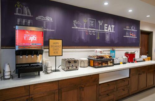 a counter in a restaurant with avertisement at Hampton Inn Colorado Springs I-25 Central in Colorado Springs