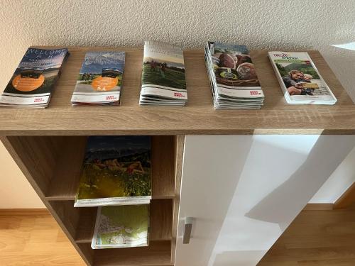 a book shelf with magazines on top of it at Ferienwohnung Schennach in Obsteig