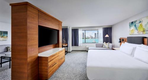 a hotel room with a bed and a flat screen tv at DoubleTree by Hilton Windsor, ON in Windsor