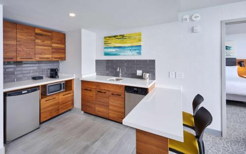 a kitchen with wooden cabinets and a white counter top at DoubleTree by Hilton Windsor, ON in Windsor
