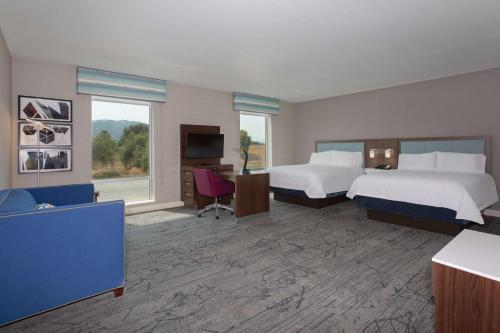 a hotel room with two beds and a television at Hampton Inn & Suites Gilroy, Ca in Gilroy