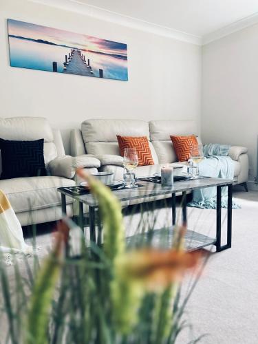 a living room with a couch and a coffee table at Deluxe 2 Bedroom Apartment in Sheffield