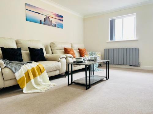 a living room with a couch and a table at Deluxe 2 Bedroom Apartment in Sheffield