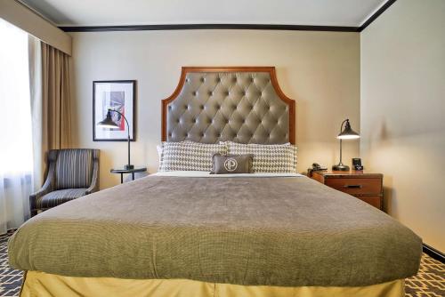 a bedroom with a large bed and a chair at The Peery Salt Lake City Downtown, Tapestry Collection by Hilton in Salt Lake City