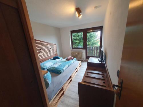 Schlafzimmer mit einem Bett und einem Fenster in der Unterkunft Ferienhaus-Schönwald, 2 Schlafzimmer, Küche, Dachterrasse, Balkon App24 in Schönwald