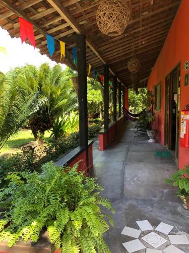 a porch of a building with plants and flags at Pousada Aba da Serra in São Joaquim do Monte