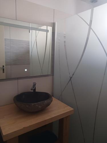 a bathroom with a sink and a mirror at Loue appartement duplex de 90m2 refait à neuf in Villefort