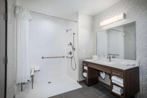 a white bathroom with a shower and a sink at Home2 Suites by Hilton Roswell, NM in Roswell