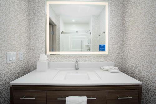 a bathroom with a sink and a mirror at Home2 Suites by Hilton Roswell, NM in Roswell