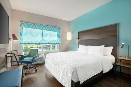 a hotel room with a bed and a chair and a window at Tru By Hilton Ringgold, Ga in Ringgold