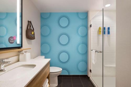 a bathroom with a toilet and a glass shower at Tru By Hilton Ringgold, Ga in Ringgold