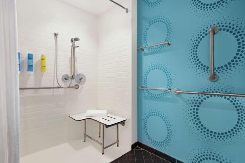 a bathroom with a shower with a blue glass door at Tru By Hilton Ringgold, Ga in Ringgold
