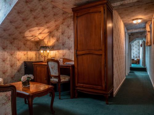 a room with a desk and a cabinet and a table at Château Des Bondons EI in La Ferté-sous-Jouarre